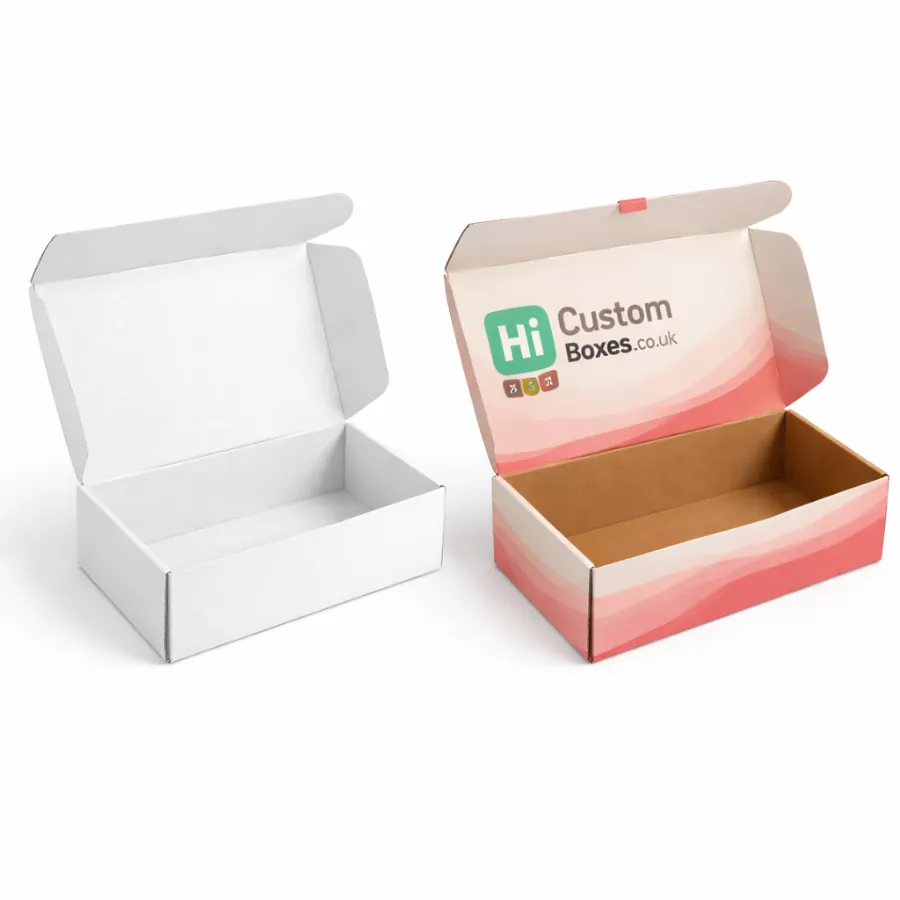 Two open cardboard mailer boxes- one plain white and one with pink wave patterns and branding- class=